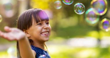 Niña jugando con burbujas